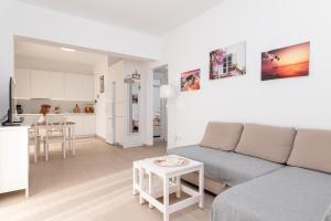 a living room with a couch and a kitchen at SeaView Apartment 1 in Samos