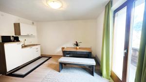 a kitchen with a table and a bench in a room at Pension Sonnegg in Gallaverda