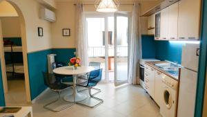 a kitchen with a table and chairs and a refrigerator at Lighthouse Ladispoli al centro in Ladispoli