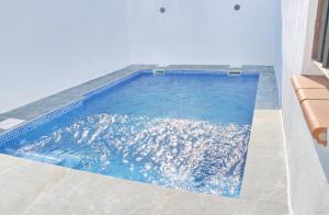 a swimming pool with blue water in a house at Chalet La Higuerita in Conil de la Frontera