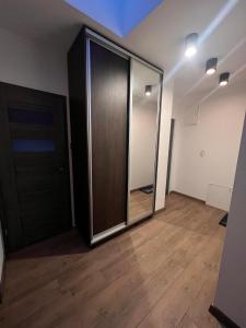 an empty room with a door and a wooden floor at Apartamenty na Maja - 6 in Skierniewice