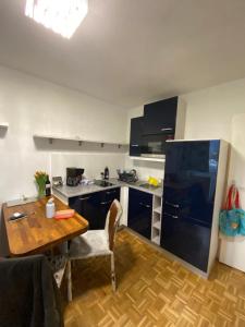 a kitchen with a wooden table and a kitchen with a dining room at Wohnung in Bahnhofsnähe mit Balkon - 35 m2 in Gmunden