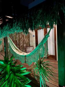 a hammock in a room with two plants at Pousada Lanea Experience in Atins