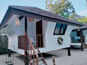 a tiny house with a porch and a staircase at Casitas de Boracay in Boracay