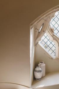 a window and a vase sitting on a shelf at Chapel House Estate in Kent