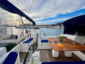 a wooden deck of a boat with a wooden table at Sailboat Euplea in Imperia