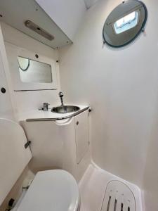 a small bathroom with a toilet and a sink at Sailboat Euplea in Imperia