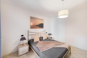 En eller flere senge i et værelse på Le Terrazze PT36 by Wonderful Italy + 25 billeder