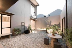 a large courtyard with a table and some plants at Creative Luxury Villa, New Year Staycation (10) 