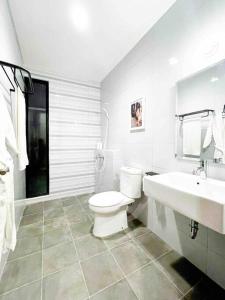 a white bathroom with a toilet and a sink at Creative Luxury Villa, New Year Staycation (10) 