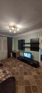 a living room with a flat screen tv and a couch at 2 bedroom apartment metro Vasilkovskaya Institut Raka in Kyiv