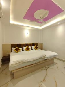 a bedroom with a bed with a ceiling at S.S Guest House in Varanasi