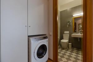 a bathroom with a washing machine and a sink at Le Port Boutique Apart Hotel in Batumi +56 photos