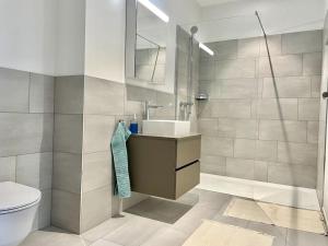 a bathroom with a sink and a toilet at Lokstadt in Winterthur