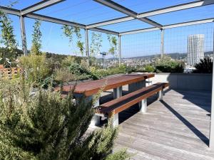 a wooden bench sitting on top of a patio at Lokstadt in Winterthur