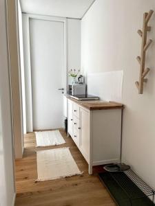 a room with a desk with a microwave on it at Lokstadt in Winterthur +3 photos