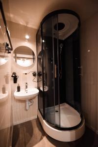 a bathroom with a shower and a sink at Viesu māja Stadula in Skrunda