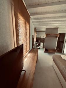 a living room with a couch and a refrigerator at Myconian Sunset Apartments in Tagou
