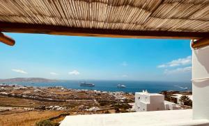 a view of the ocean from a building at Myconian Sunset Apartments in Tagou