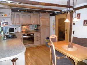 a kitchen with a wooden table and a dining room at Ferienhaus Zweite Straße in Neuenrade