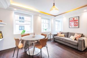 a living room with a couch and a table and chairs at Welcome London Covent Garden in London