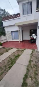 a motorcycle parked in front of a house at departamento cucú in Villa Carlos Paz