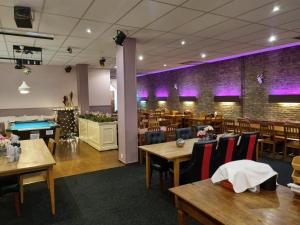a dining room with tables and a pool table at Hotel Dupuis in Valkenburg