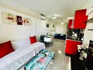 a living room with a white couch and a kitchen at Santa Maria Ocean View in Adeje