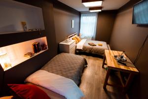 a small room with two beds and a table at Viesu māja Stadula in Skrunda