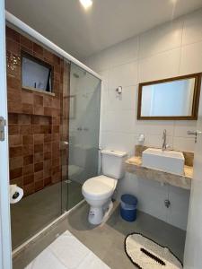 a bathroom with a toilet and a sink and a shower at Pousada do lago in Guaramiranga