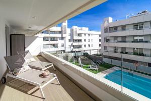 - un balcon avec une chaise et une piscine dans un bâtiment dans l'établissement Aqua 6 1A, à Marbella