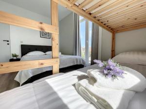 a bedroom with two beds and a large window at Loft Monaco - Ruime vakantieloft in De Panne