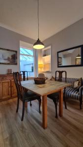 a dining room with a wooden table and chairs at Comfy home very close to Cardiff in Barry