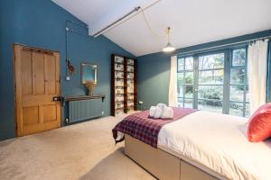 a bedroom with a bed and a large window at GuestReady - Elegant home in Manchester in Manchester