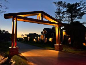 a wooden structure with lights on a street at Verbier New Luxurious Condo 2bdrm spa-pool-sauna in Mont-Tremblant
