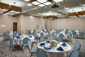 a banquet hall with white tables and blue chairs at Four Points by Sheraton Yuma in Yuma