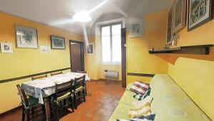ein Esszimmer mit einem Tisch, Stühlen und einem Fenster in der Unterkunft La Bandinella in Albissola Marina