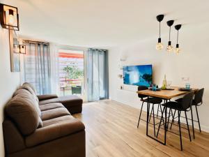 a living room with a couch and a table at PaulMarie Apartment in Olympia in Playa de las Americas