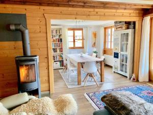 a living room with a fireplace and a table in a room at Chalet an sonniger aussichtsreicher Lage in Mund