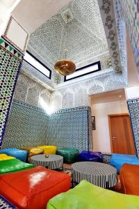 a room with colorful stools in a room with a ceiling at Domaine K Marrakech in Marrakesh