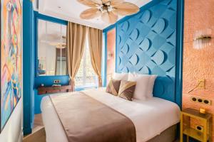a bedroom with a large bed with blue walls at Luxury 4 Bedroom 3 Bathroom - Louvre & Marais in Paris