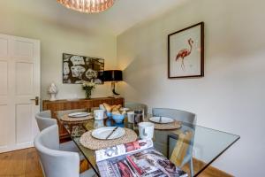 a dining room with a glass table and chairs at Rawlinson Road 10A in Oxford