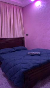 a bedroom with a purple room with a bed at Chic 3 Bed Villa in heart of Agadir in Agadir