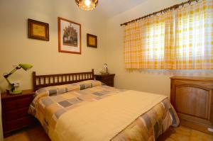 a bedroom with a bed and a dresser and a window at VALL GRAN 3 in L'Estartit +18 photos
