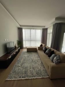 a large living room with a couch and a television at Premium hotel apartment Aeon towers Sheikh Zayed City in 6th Of October
