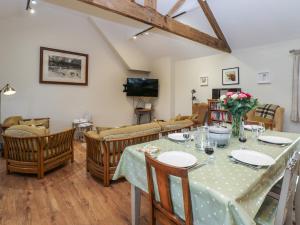 a dining room with a table and chairs at Brookside Byre in Brancepeth