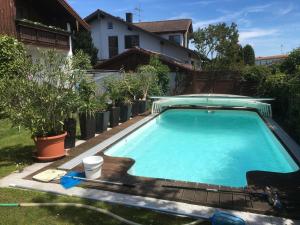 a swimming pool in the backyard of a house at Ferienwohnungen Christoph in Pfaffing