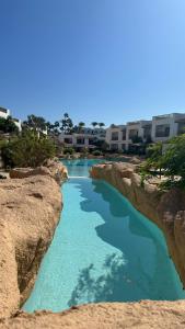 a river between two rocks with blue water at Domina coral bay elisir SPA in Sharm El Sheikh