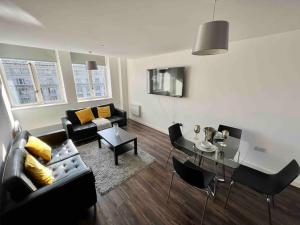 a living room with a couch and a table at Liverpool Waterfront Apartment in Liverpool