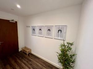 a room with four pictures on the wall at Liverpool Waterfront Apartment in Liverpool